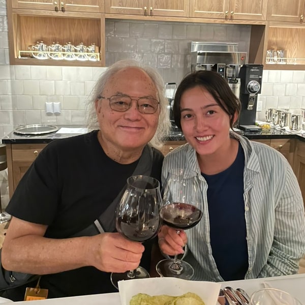 Lauren and Dad smiling and raising glasses together