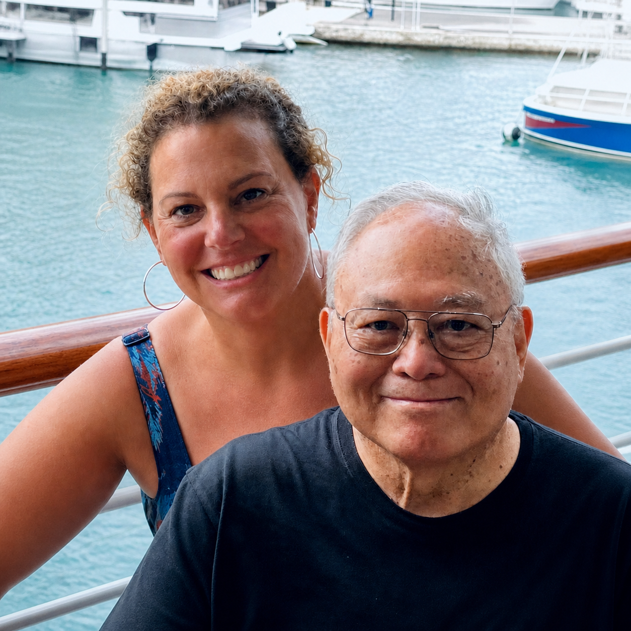 Marcie and Gene smiling together by the waterfront
